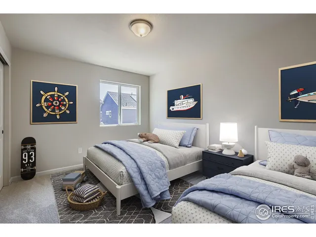 a bedroom with two beds and a desk