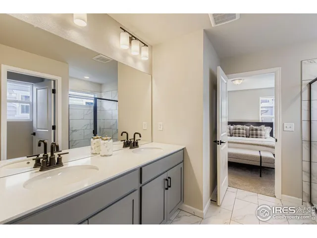 a bathroom with a sink double vanity and a mirror