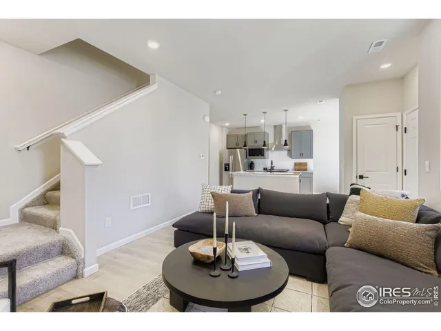 a living room with furniture and a dining table