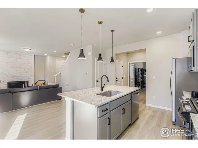 a kitchen with a sink a counter space and stainless steel appliances