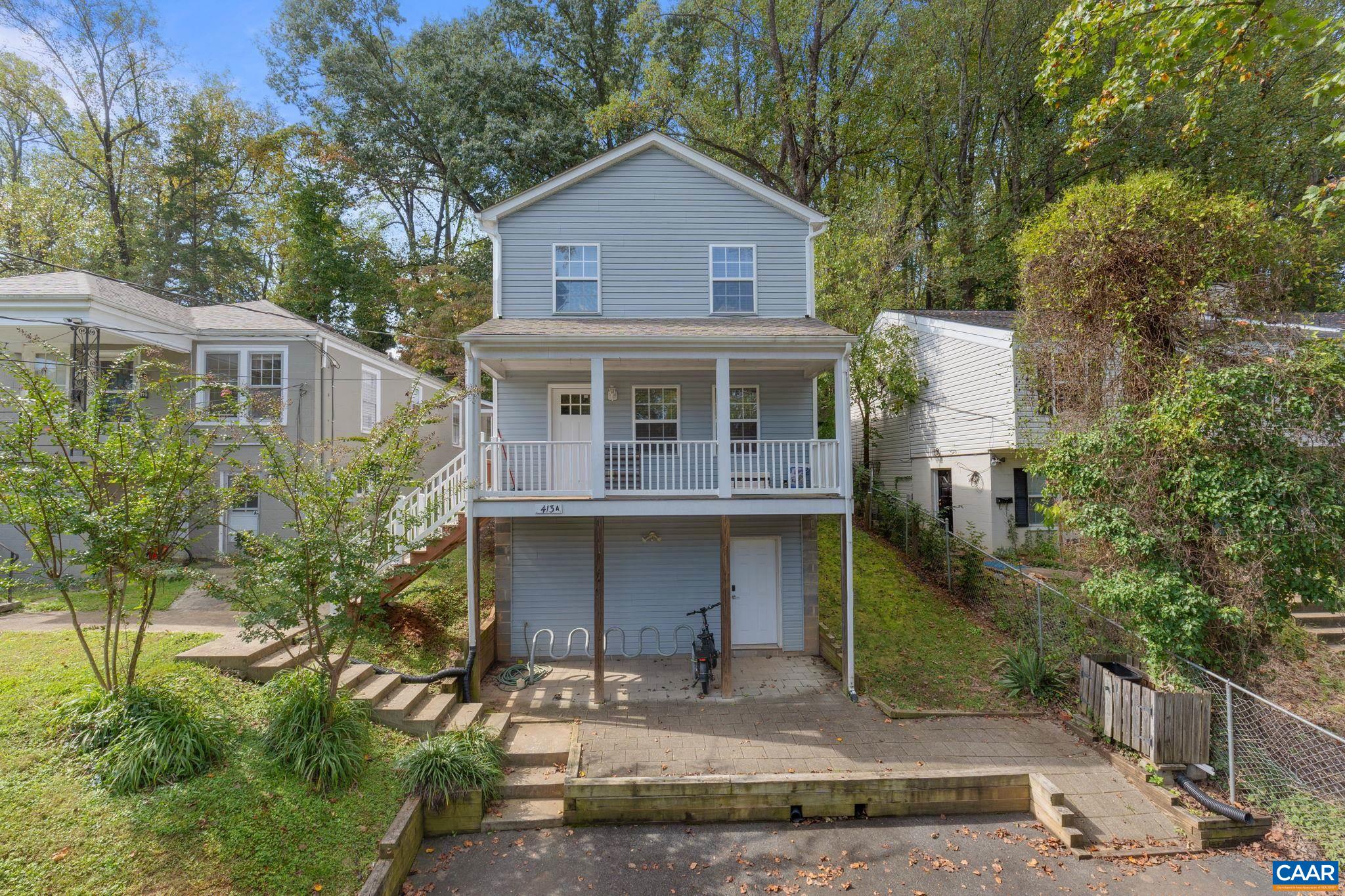 413 Valley Rd Extension Charlottesville, VA 22903 - Photo 1 of 18 a front view of a house with a yard and garage