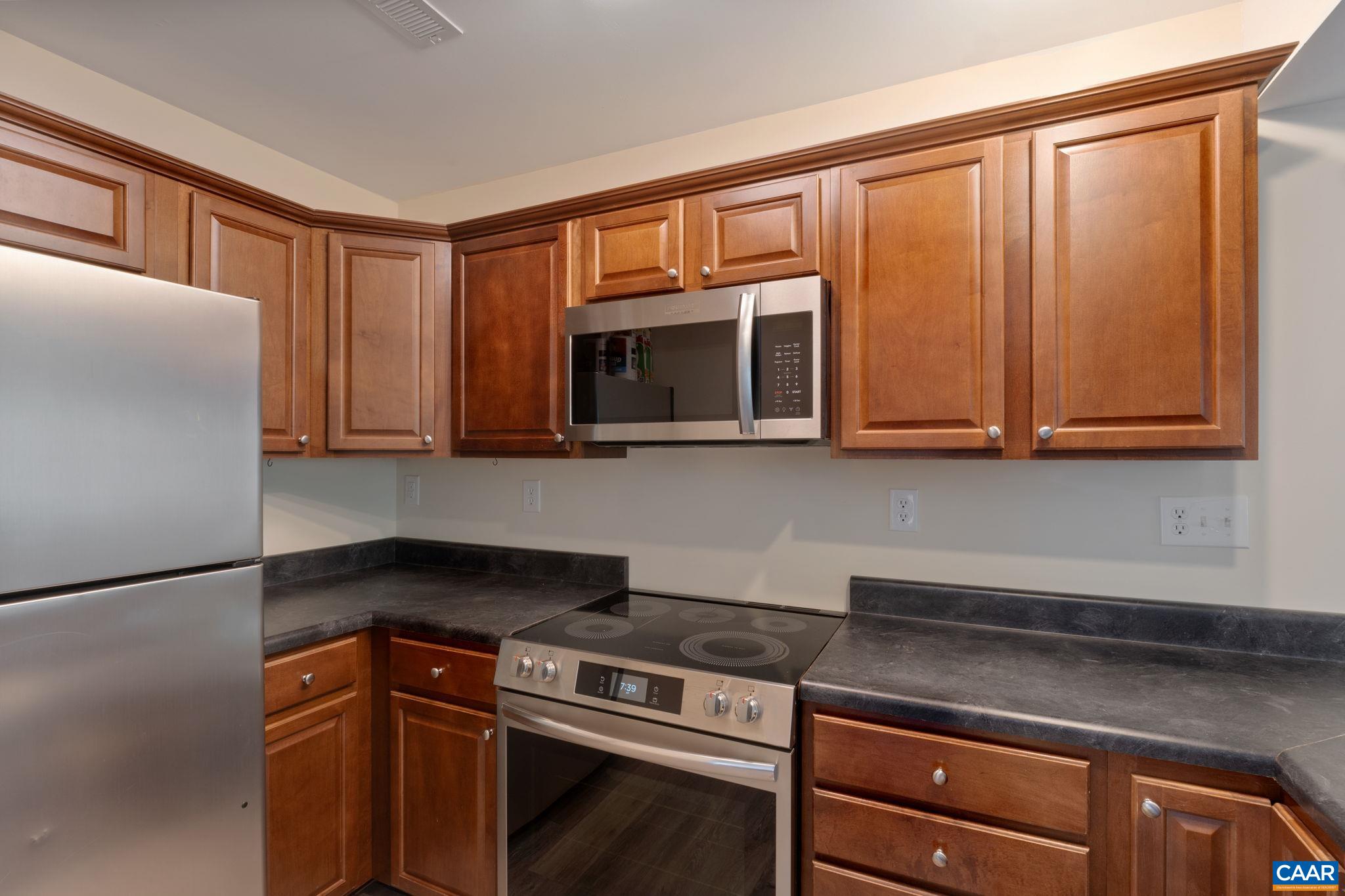 413 Valley Rd Extension Charlottesville, VA 22903 - Photo 4 of 18 a kitchen with stainless steel appliances granite countertop a stove a microwave and a refrigerator