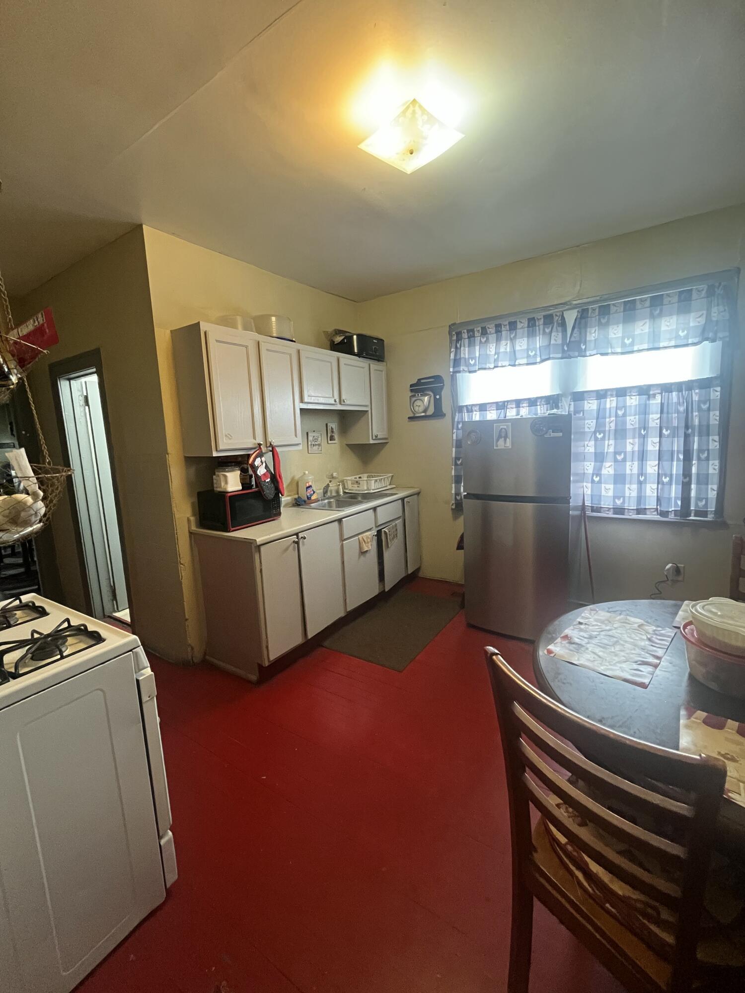 3540 Pennsylvania Street Gary, IN 46409 - Photo 8 of 23 a kitchen with sink refrigerator and window