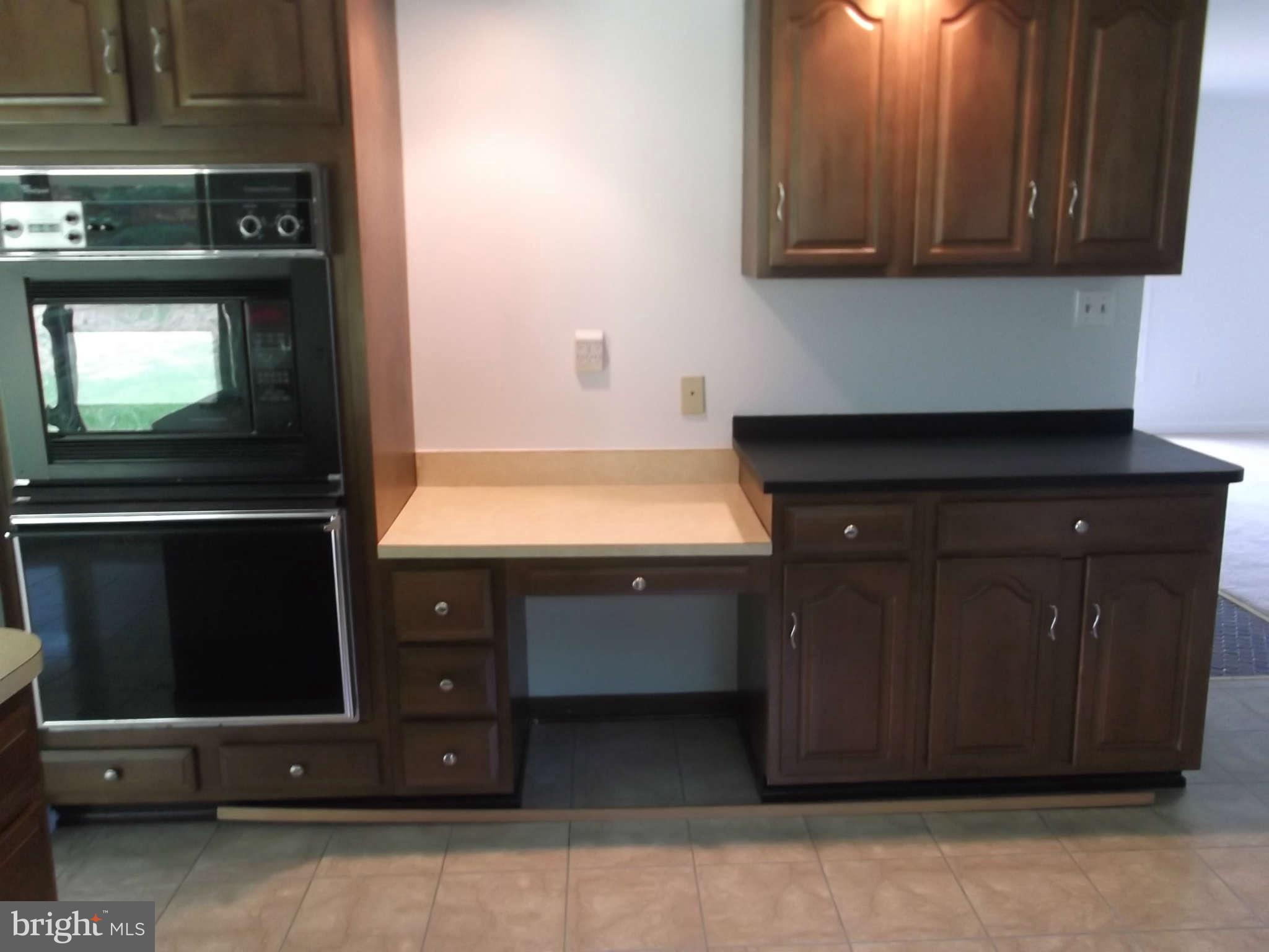 3317 Mt Carmel Road Upperco, MD 21155 - Photo 19 of 21 a kitchen with stainless steel appliances wooden cabinets and a stove top oven