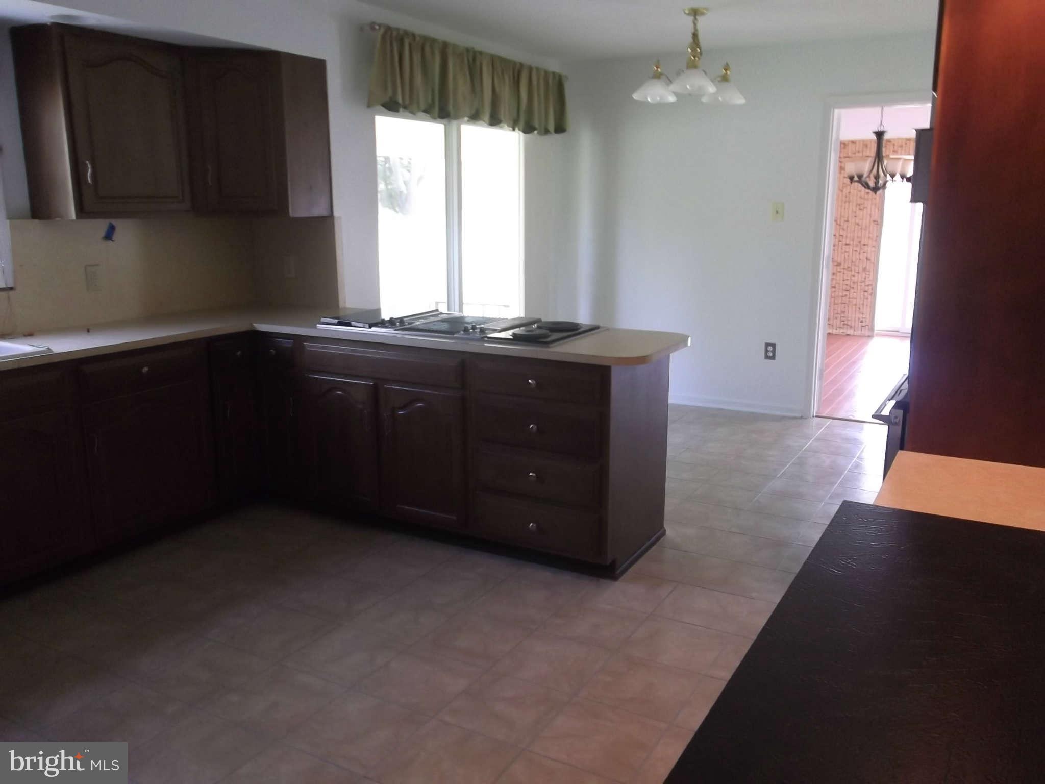 3317 Mt Carmel Road Upperco, MD 21155 - Photo 21 of 21 a kitchen with a sink a window and cabinets