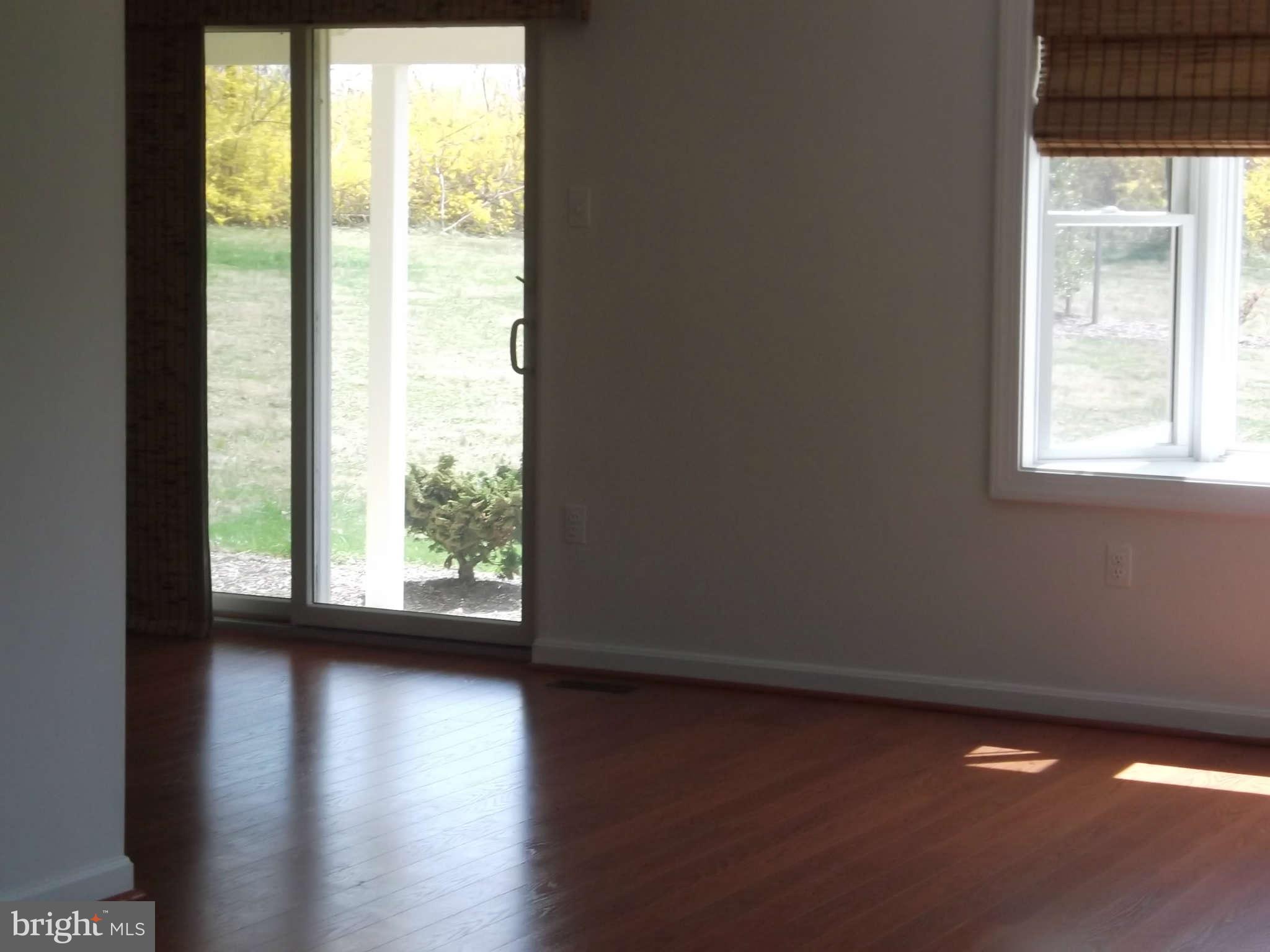 3317 Mt Carmel Road Upperco, MD 21155 - Photo 7 of 21 a view of empty room with wooden floor and fan