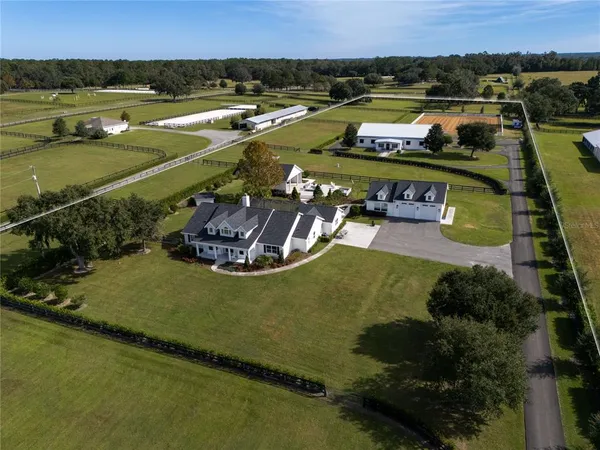 an aerial view of a house with a lake view
