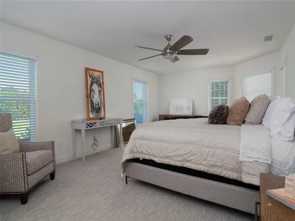 a bedroom with a bed couch and window