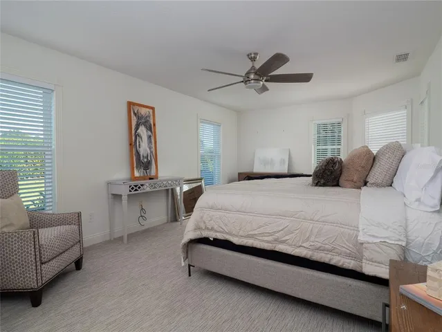 a bedroom with a bed couch and window