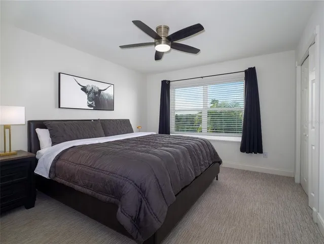 a bedroom with a large bed and a large window