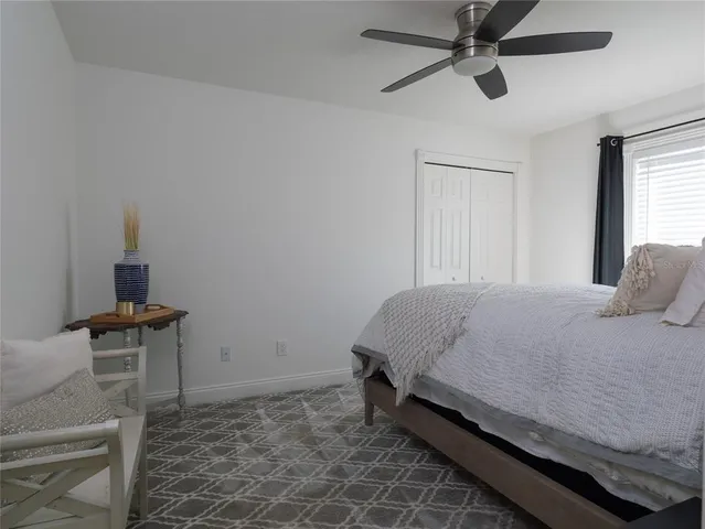 a bedroom with a bed and a table in it