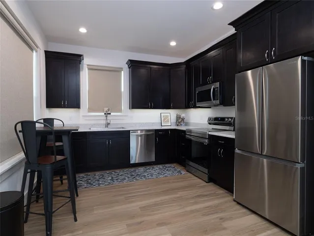 a kitchen with a refrigerator and a sink