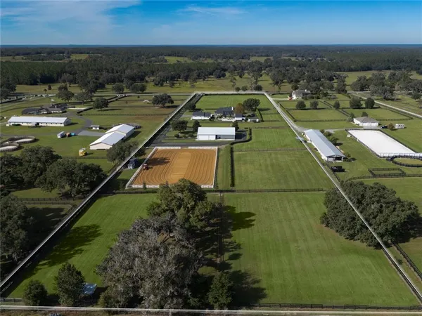 an aerial view of a residential houses with outdoor space