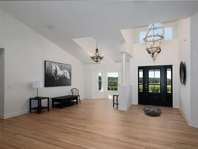 a view of a livingroom with furniture a dinning room and wooden floor