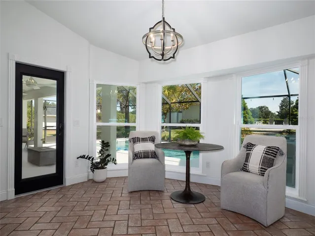 a living room with fireplace furniture and a large window