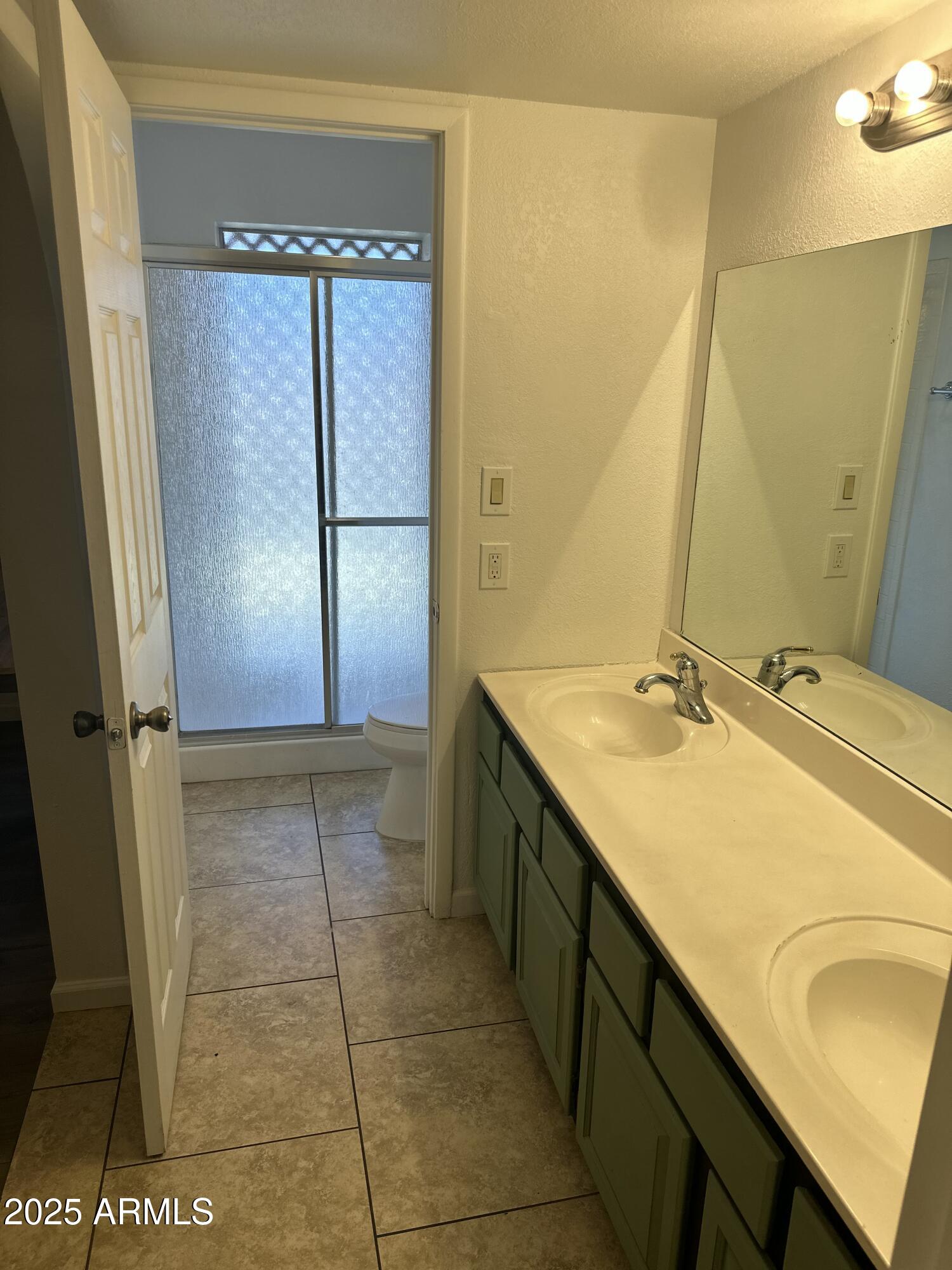1316 North Spring Circle Mesa, AZ 85203 - Photo 10 of 14 a bathroom with a double vanity sink and mirror