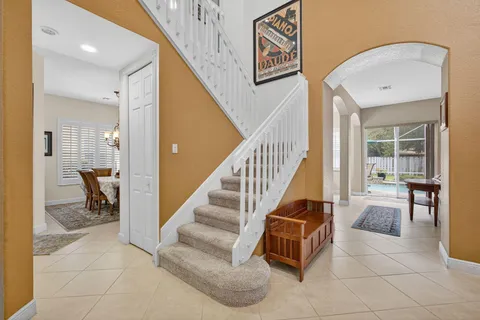 a living room with furniture a rug and a large window