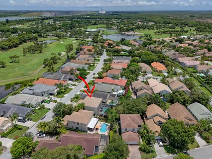 a view of a backyard with swimming pool and sitting area