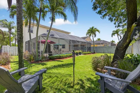 an aerial view of a house with yard swimming pool and outdoor seating
