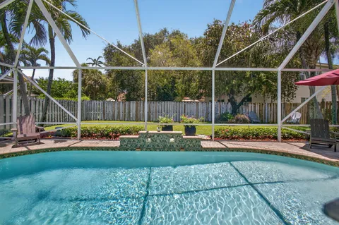 a living room with furniture a chandelier and a window