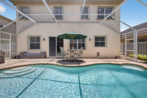 an aerial view of a house a yard and mountain view in back