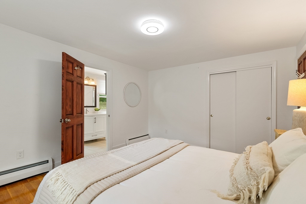 20 Oxbow Road Lexington, MA 02421 - Photo 16 of 30 a bedroom with a bed and a mirror