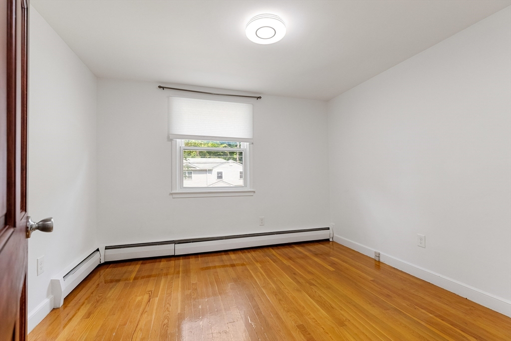 20 Oxbow Road Lexington, MA 02421 - Photo 20 of 30 a view of a room with wooden floor and window