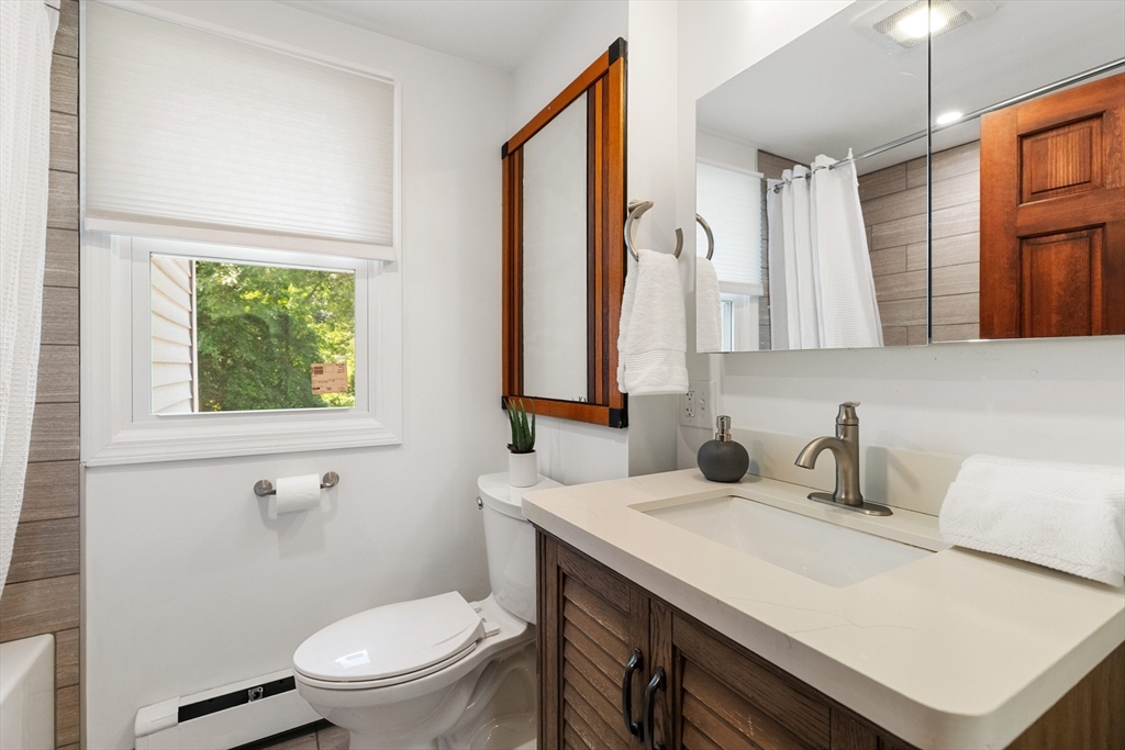 20 Oxbow Road Lexington, MA 02421 - Photo 22 of 30 a bathroom with a sink a toilet and a mirror
