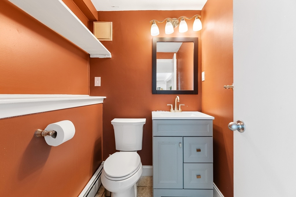 20 Oxbow Road Lexington, MA 02421 - Photo 26 of 30 a bathroom with a toilet sink vanity granite and mirror