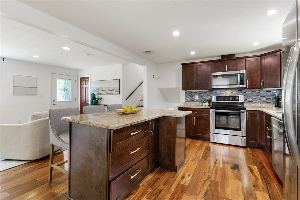 20 Oxbow Road Lexington, MA 02421 - Photo 5 of 30 a kitchen with stainless steel appliances granite countertop a stove and a sink