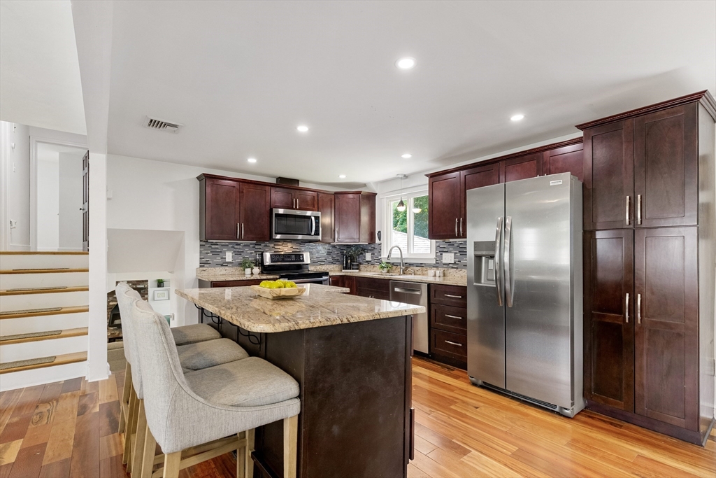 20 Oxbow Road Lexington, MA 02421 - Photo 6 of 30 a kitchen with stainless steel appliances granite countertop a refrigerator a stove a sink a oven and a refrigerator