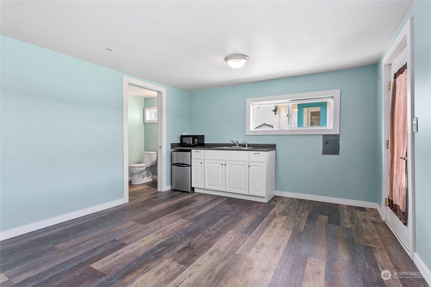 2404 I Street Bellingham, WA 98225 - Photo 32 of 38 a kitchen with wooden floors and white cabinets