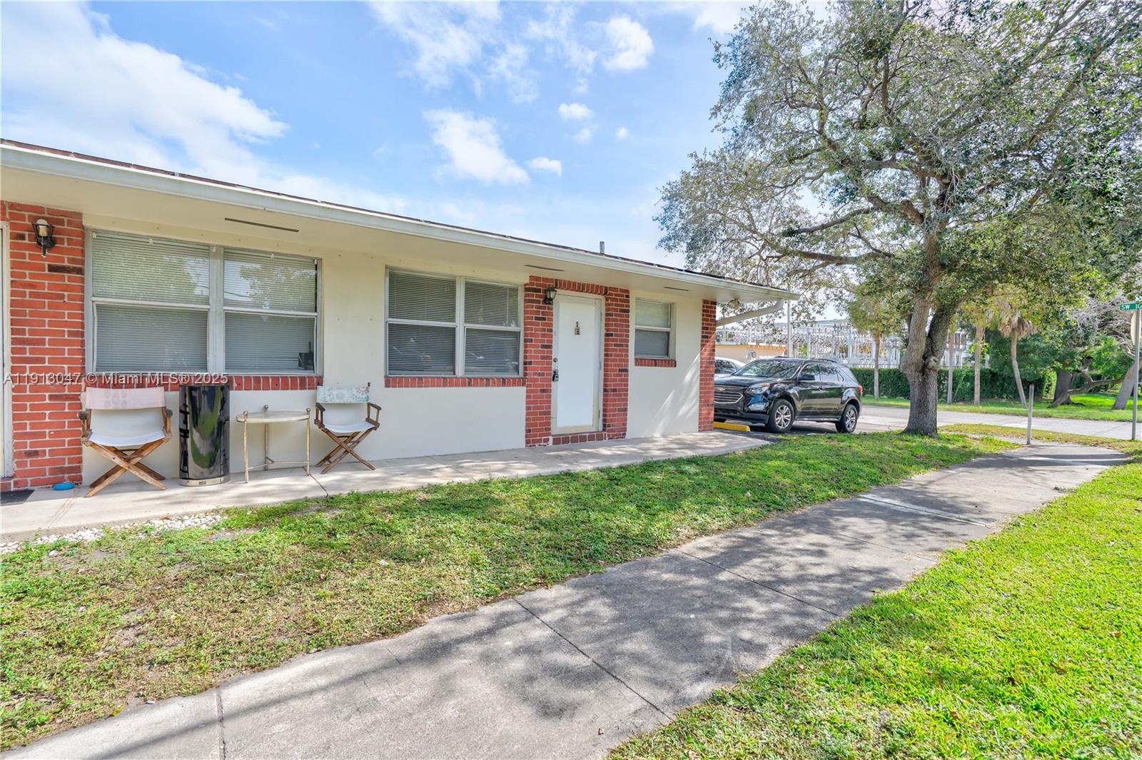 856 Southwest 10th Street, Unit 1 Hallandale Beach, FL 33009 - Photo 2 of 15 a front view of house with yard patio and green space