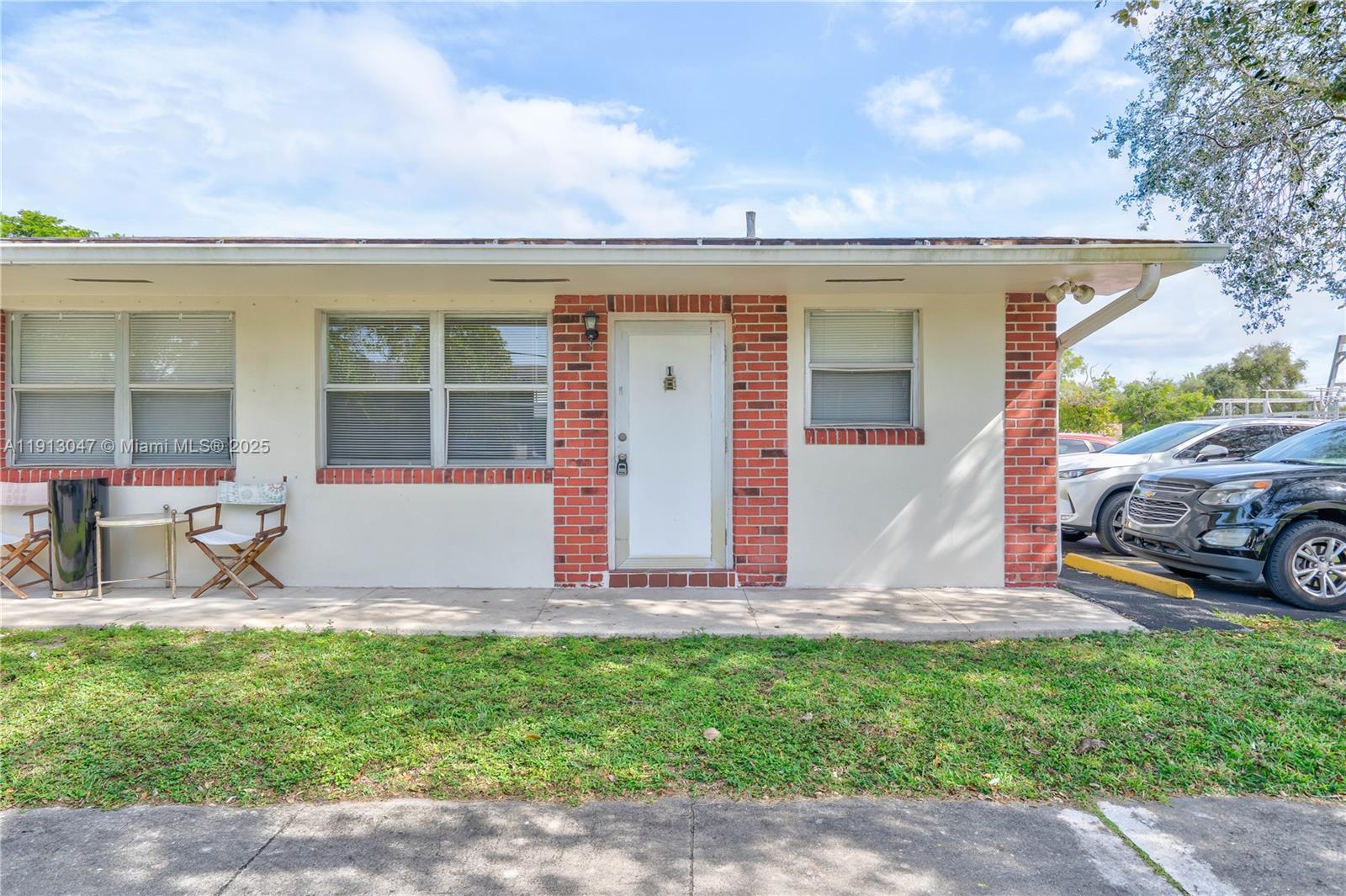 856 Southwest 10th Street, Unit 1 Hallandale Beach, FL 33009 - Photo 3 of 15 a front view of a house with garden