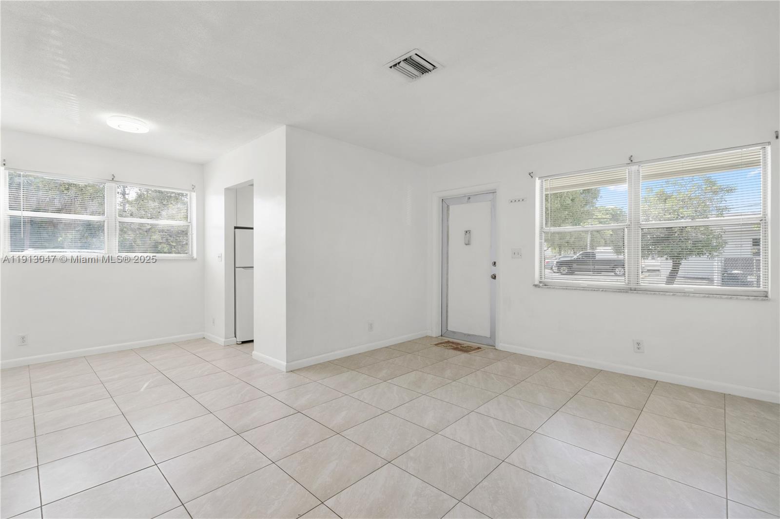856 Southwest 10th Street, Unit 1 Hallandale Beach, FL 33009 - Photo 5 of 15 a view of an empty room with a window