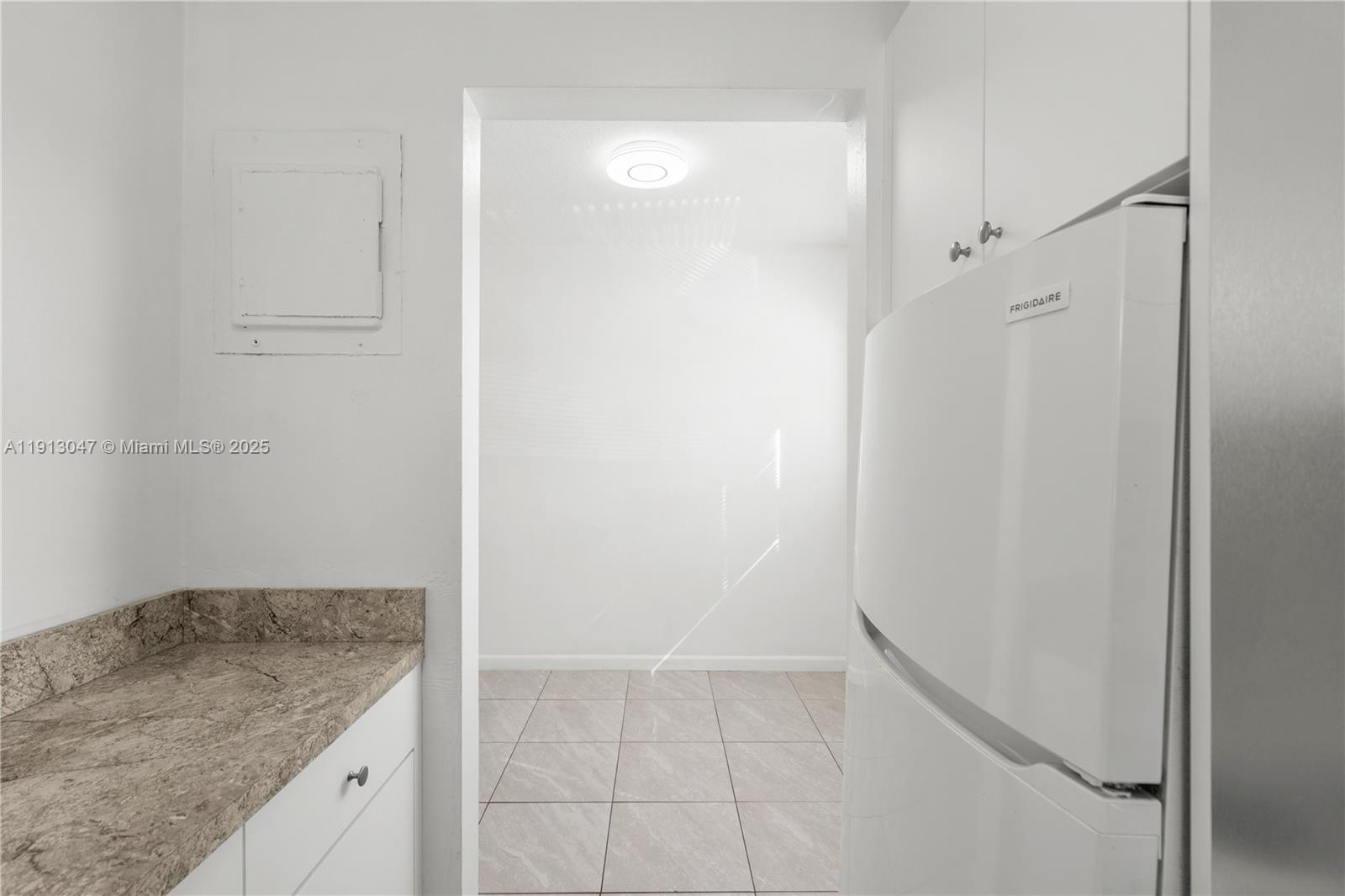 856 Southwest 10th Street, Unit 1 Hallandale Beach, FL 33009 - Photo 7 of 15 a bathroom with a granite countertop sink and a mirror