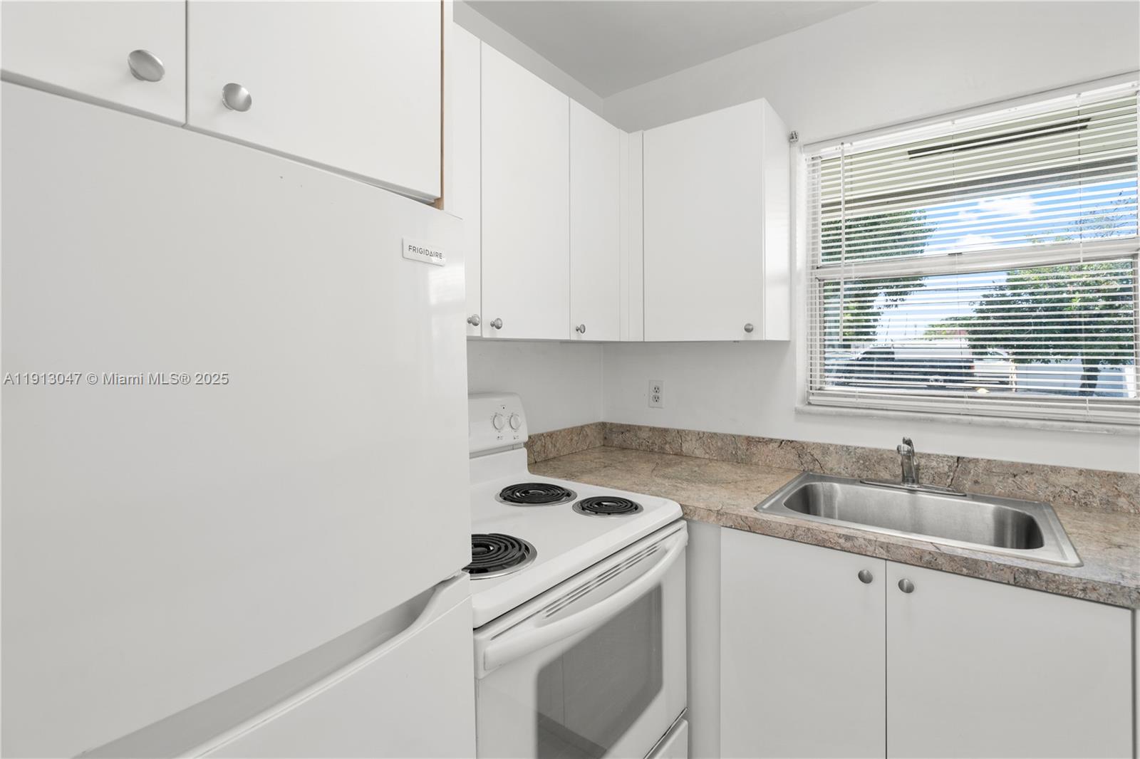 856 Southwest 10th Street, Unit 1 Hallandale Beach, FL 33009 - Photo 9 of 15 a view of a kitchen with sink and washer