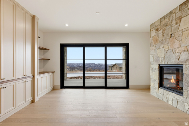 2155 East Wrangler Road Kamas, UT 84036 - Photo 17 of 62 Unfurnished living room with a stone fireplace, light wood finished floors, and recessed lighting