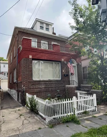 a front view of a house with a fence
