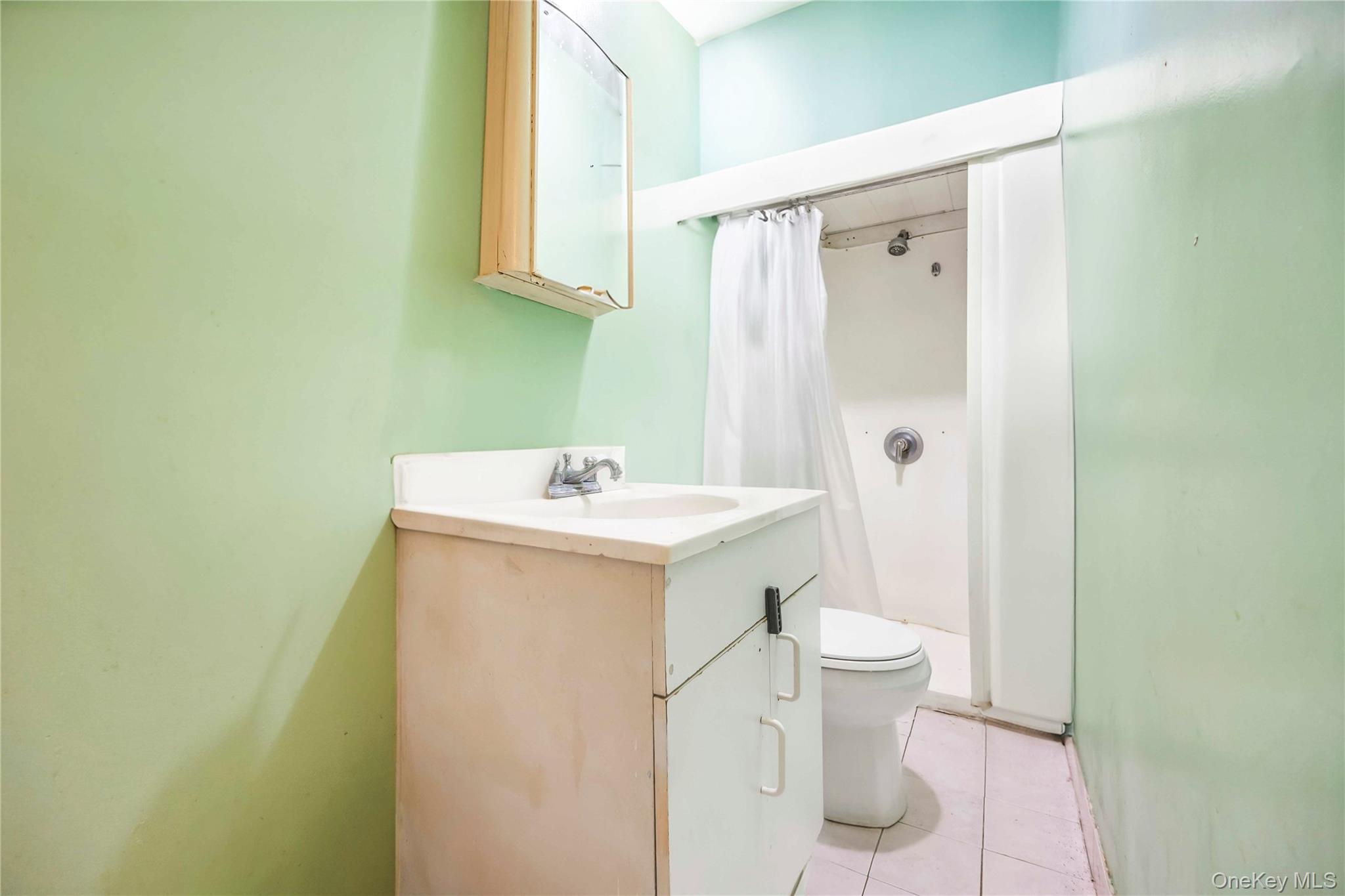 55-14 98th Street Queens, NY 11368 - Photo 16 of 49 a bathroom with a sink toilet and shower
