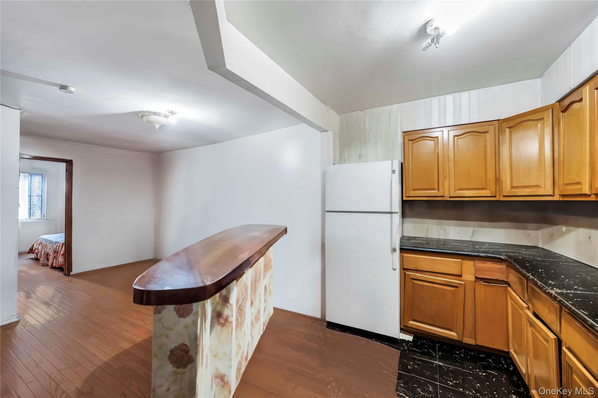 55-14 98th Street Queens, NY 11368 - Photo 18 of 49 a kitchen with a refrigerator and cabinets