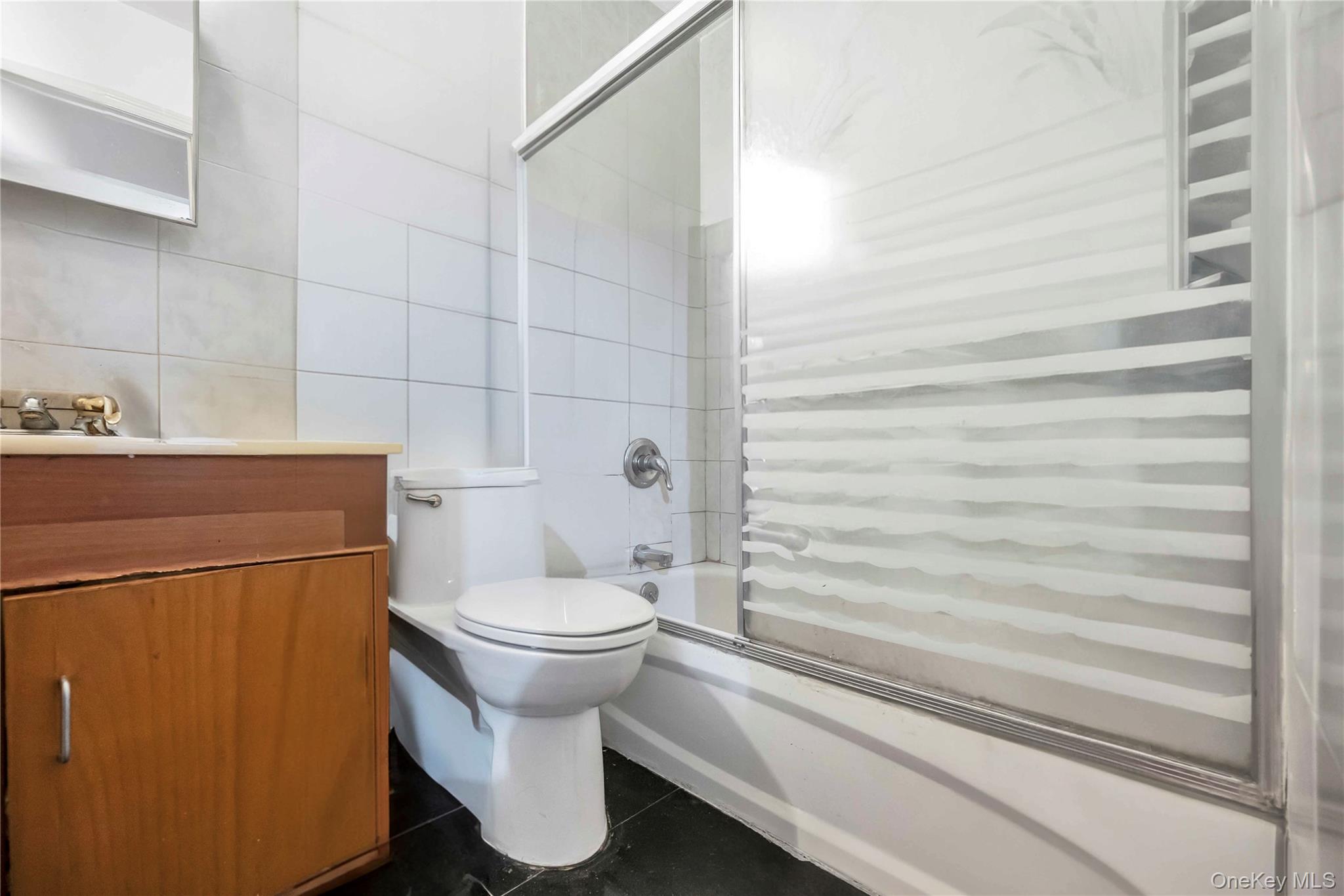 55-14 98th Street Queens, NY 11368 - Photo 21 of 49 a bathroom with a toilet and a shower
