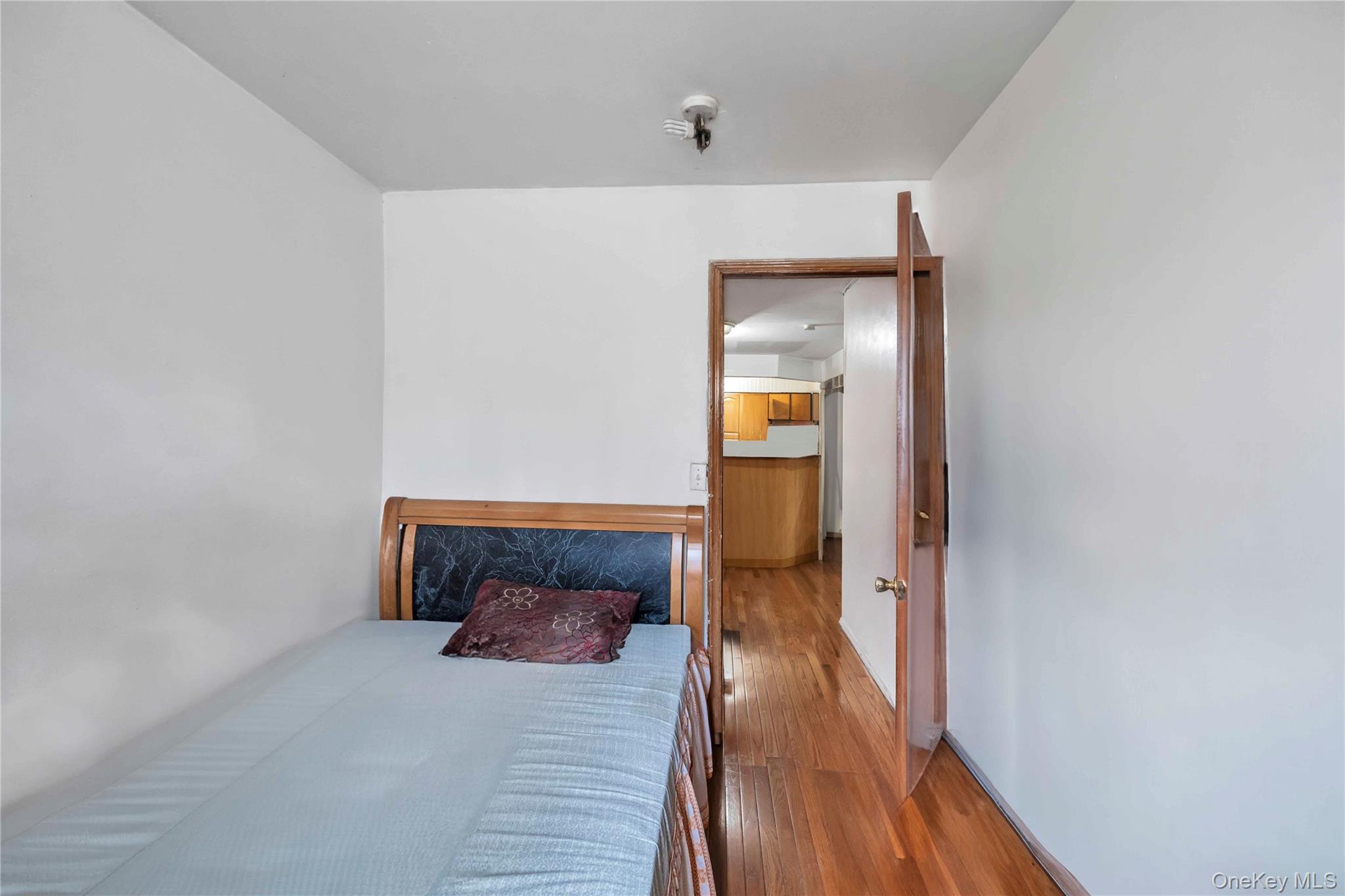 55-14 98th Street Queens, NY 11368 - Photo 23 of 49 a hallway with wooden floor table and chair