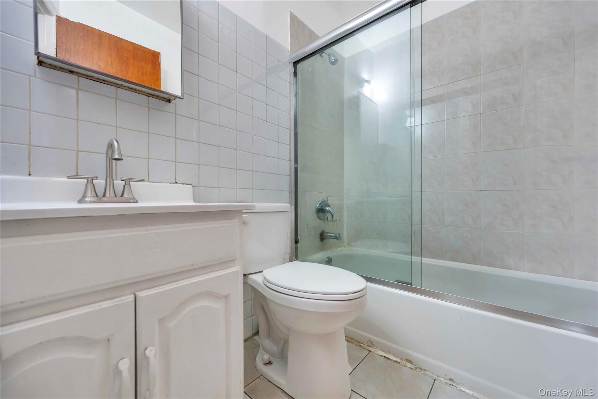 55-14 98th Street Queens, NY 11368 - Photo 34 of 49 a bathroom with a sink a toilet and shower