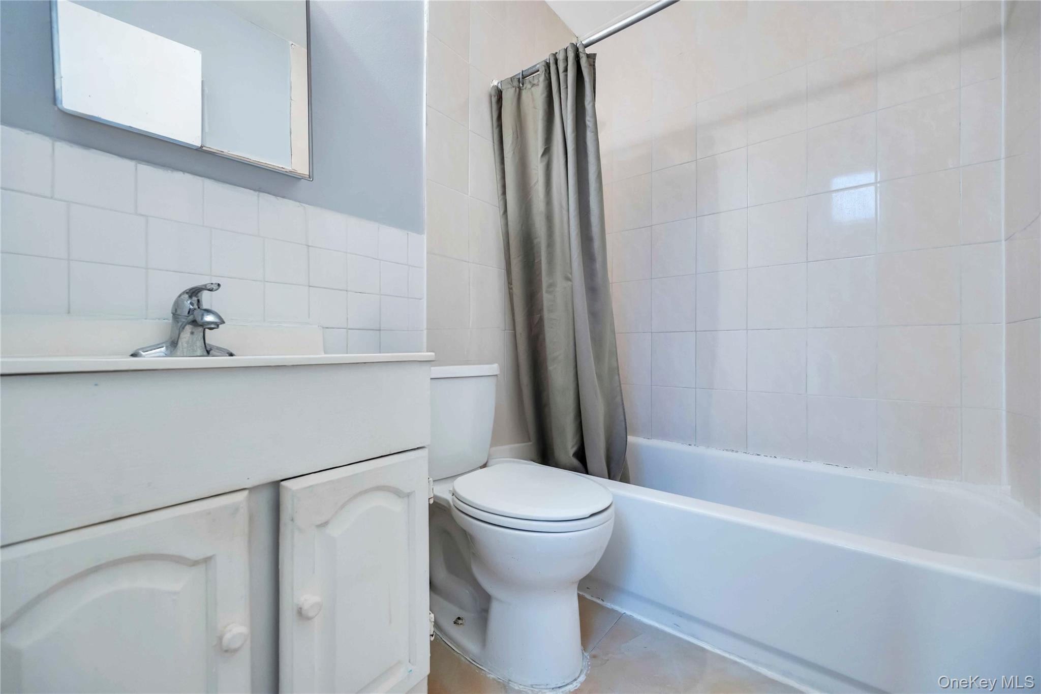 55-14 98th Street Queens, NY 11368 - Photo 40 of 49 a bathroom with a sink a toilet and a bathtub