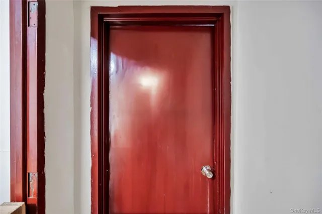 a view of an empty room and kitchen