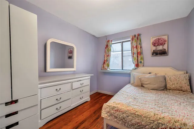 a bedroom with a bed and a night stand