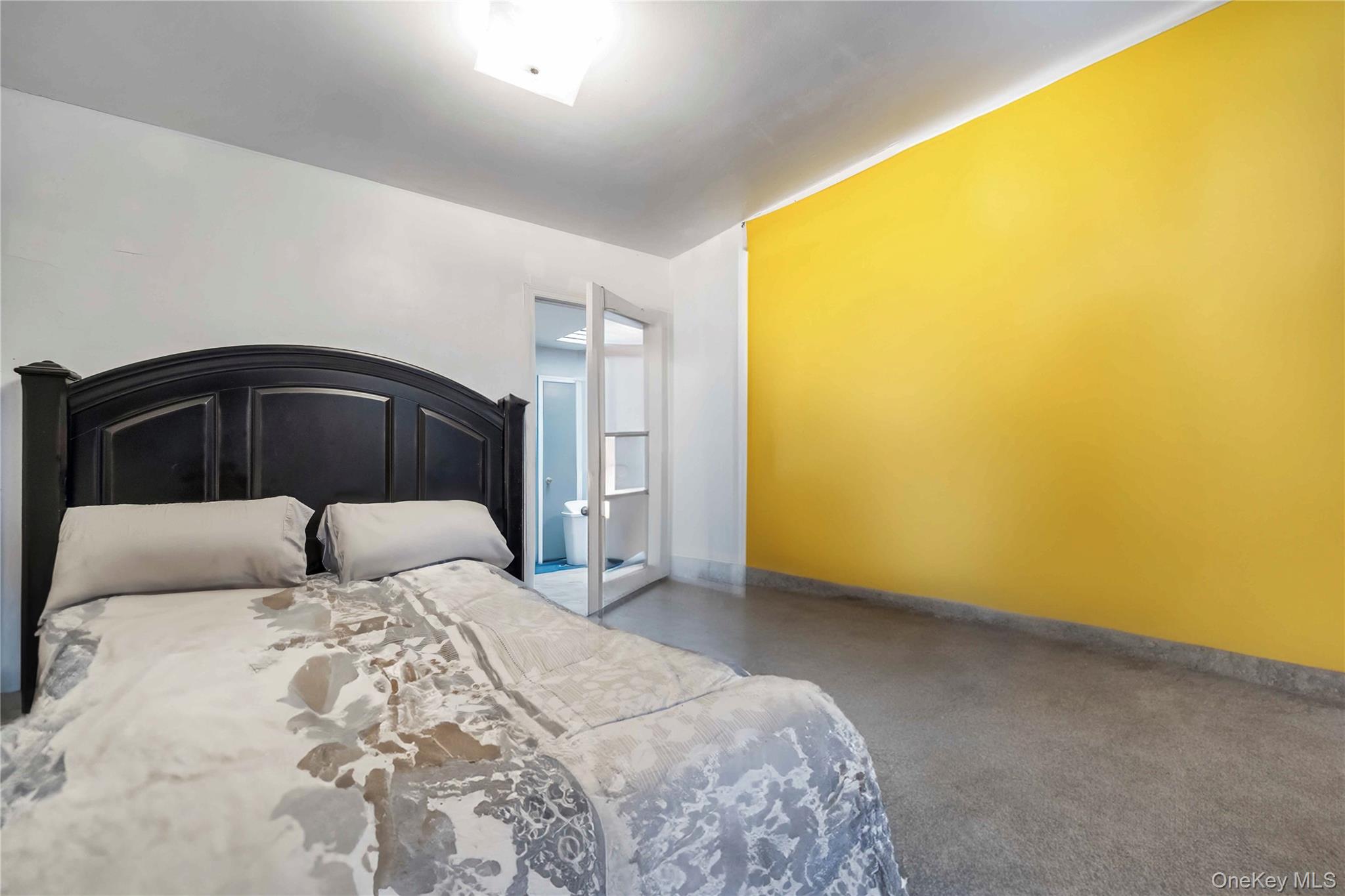 55-14 98th Street Queens, NY 11368 - Photo 47 of 49 a bedroom with a bed and a night stand