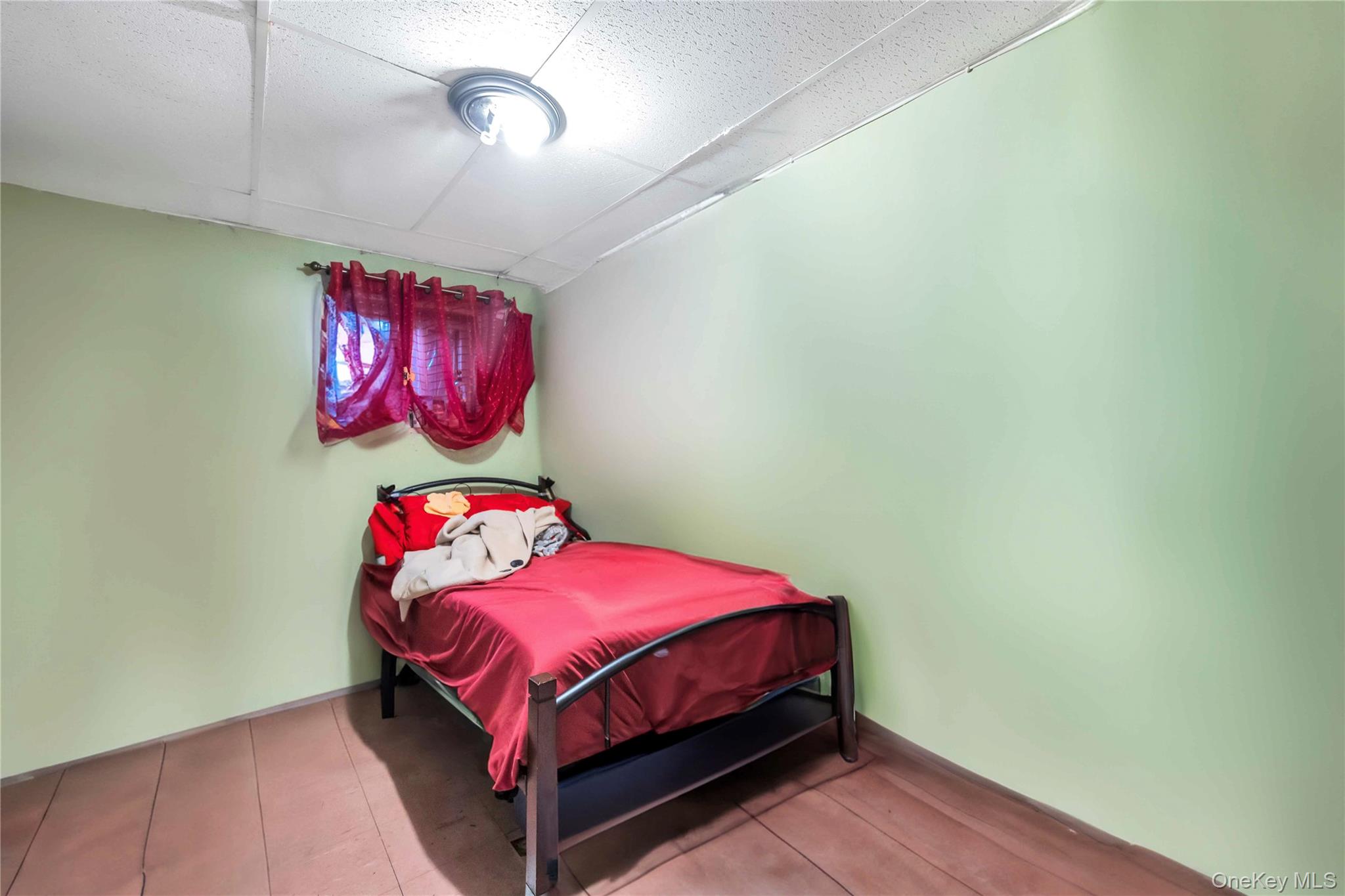 55-14 98th Street Queens, NY 11368 - Photo 5 of 49 a bedroom with a bed and a chandelier