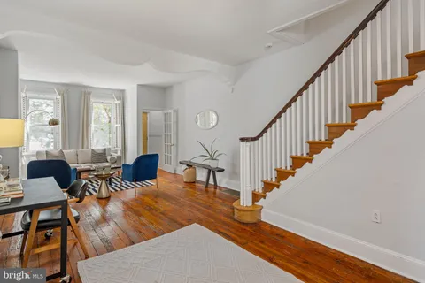 a view of entryway and hall with wooden floor